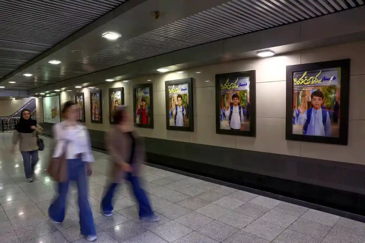 Images depicting the Minab School students who were killed in a strike are displayed at Valiasr Square in Tehran.