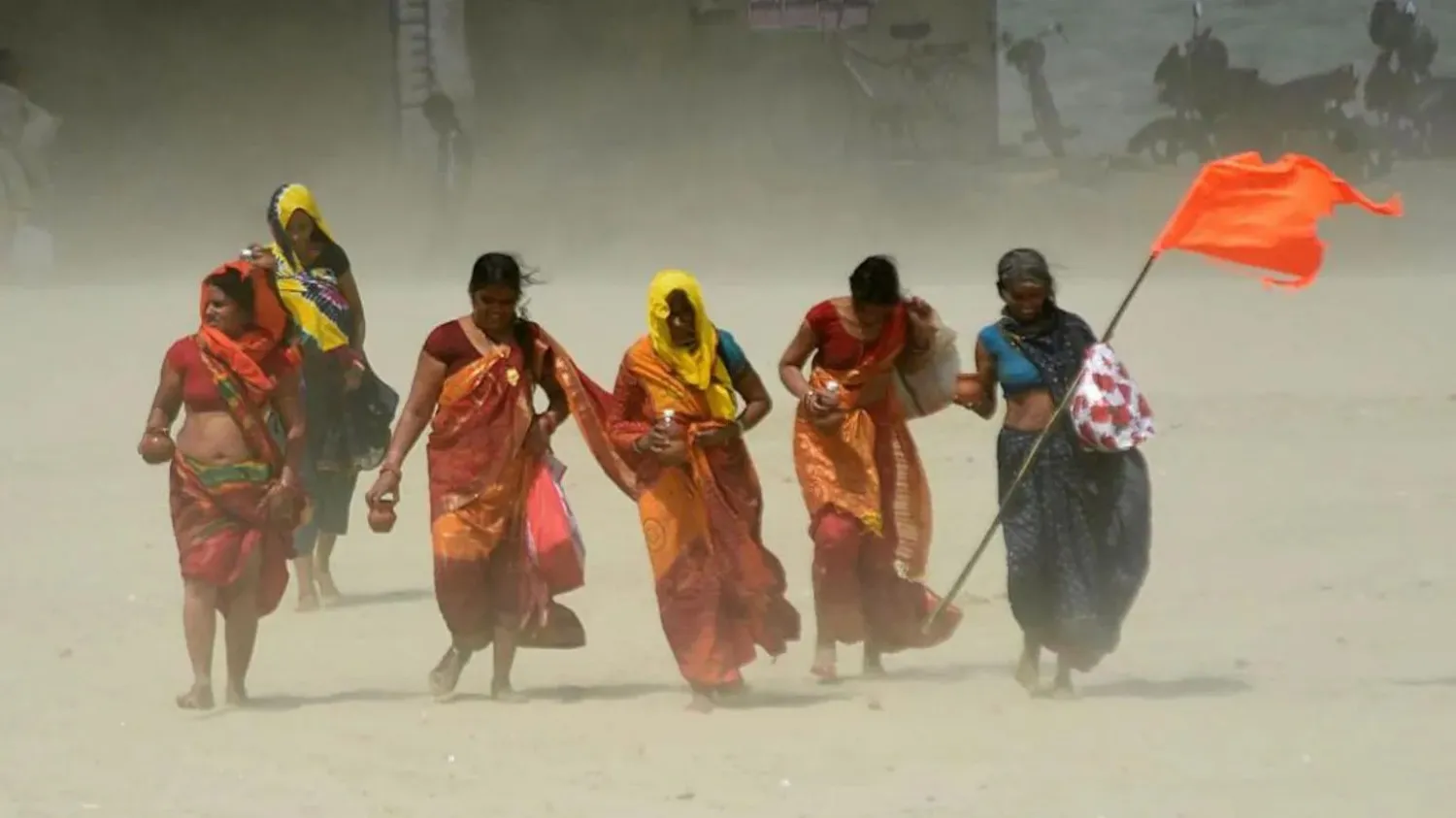 Woman is walking, and the hot wind is blowing.