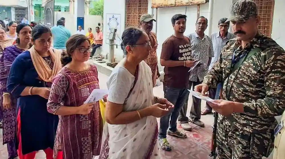People are standing in lines to cast their votes.