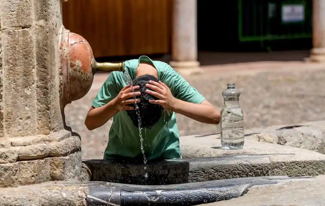 A tourist cools off during the heatwave, which has brought daytime highs of up to 42C and sweltering nights in Spain.