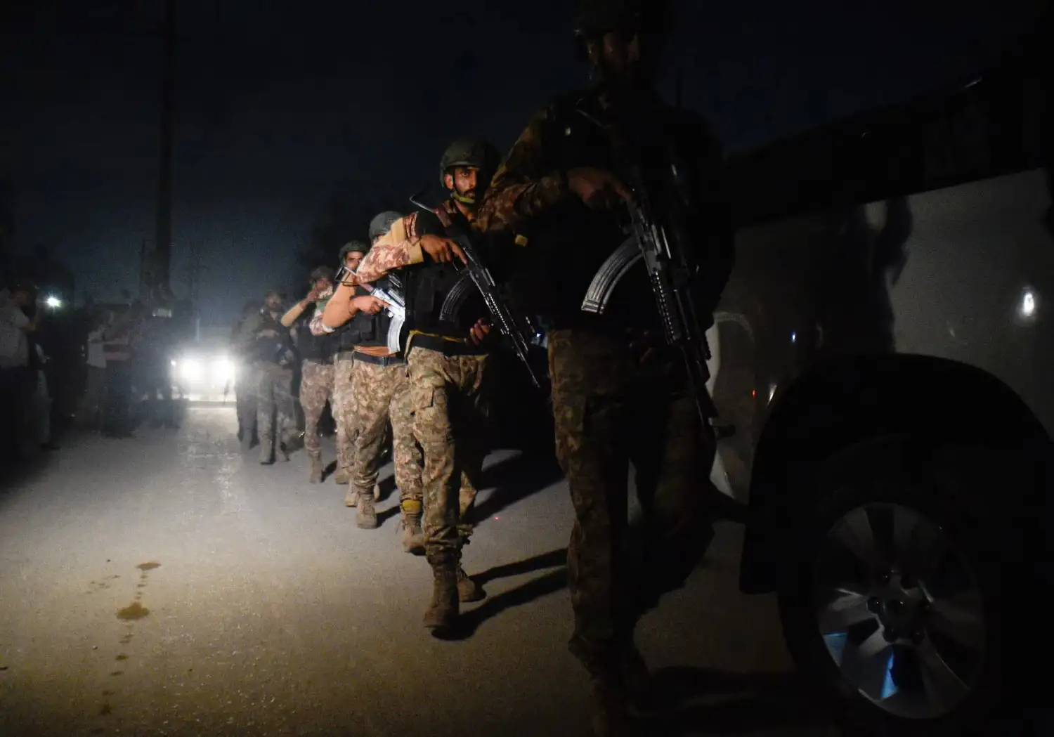 Security personnel patrols after an explosion and gunfire were reported, near offices of the Rangers, a paramilitary force, in Karachi, Pakistan,