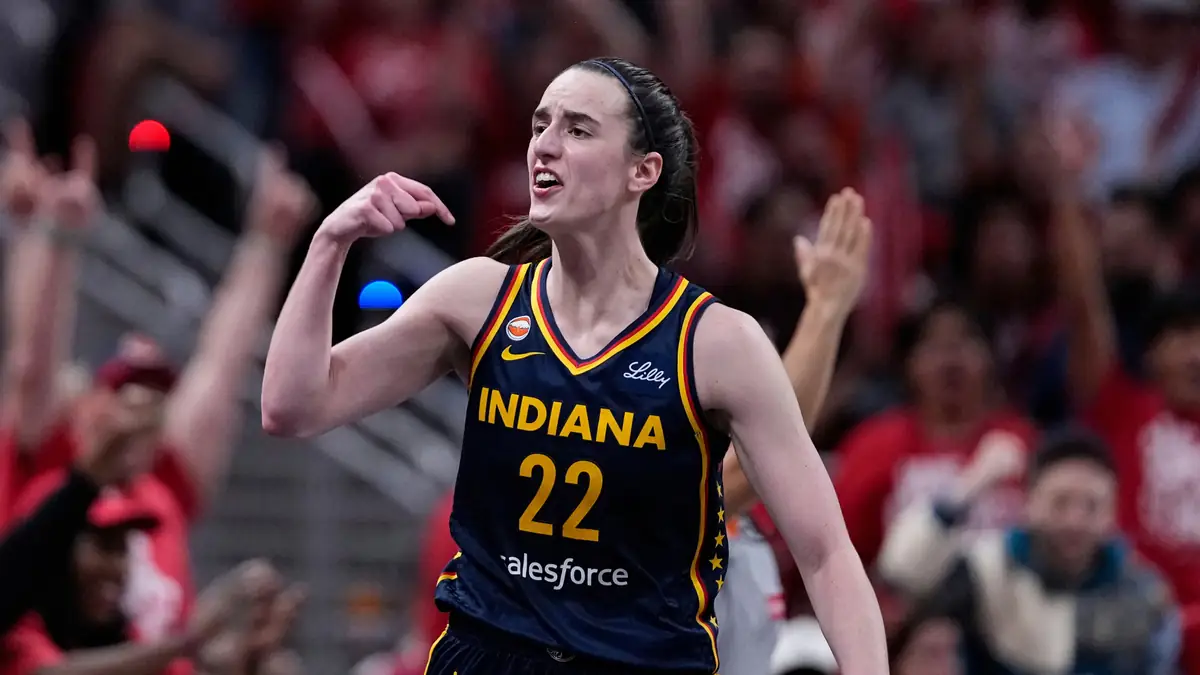 Indiana Fever basketball player wearing jersey number 22 celebrates during a game in front of the crowd.
