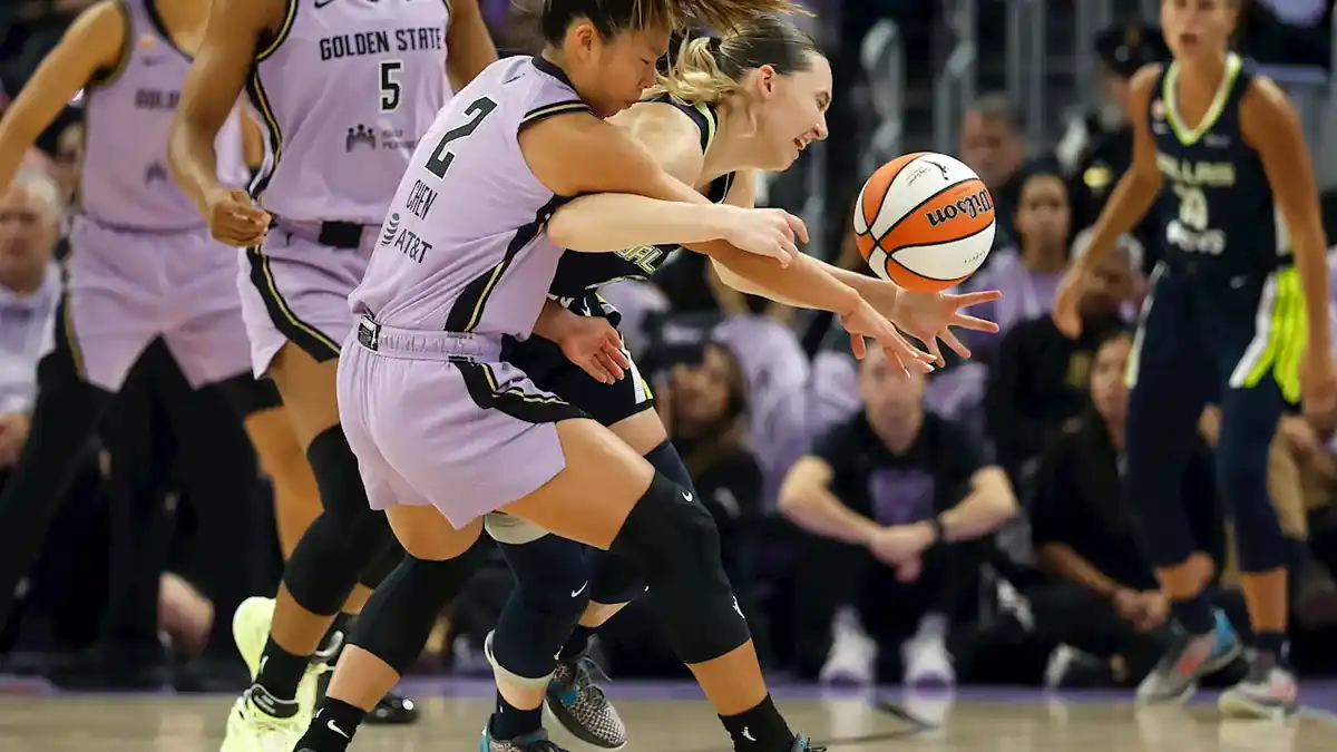 Golden State Valkyries players battle for the ball during a WNBA playoff game.