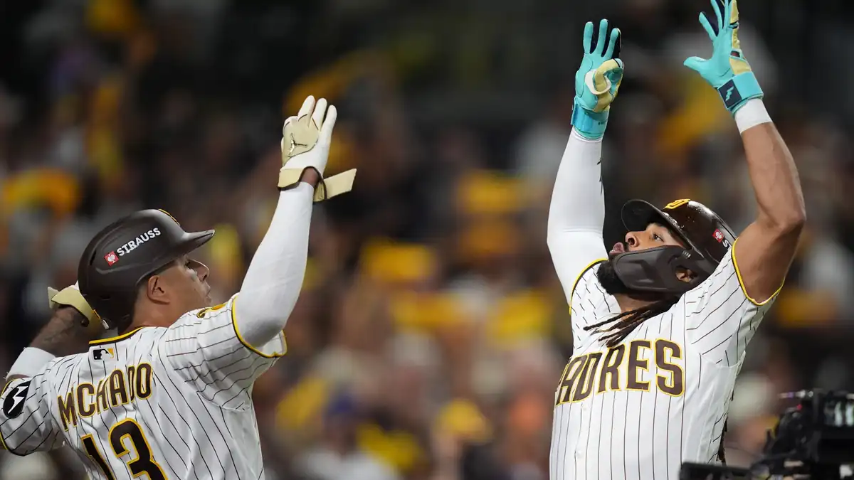 Padres' Fernando Tatis Jr. and Manny Machado (13) celebrate back-to-back first-inning homers in Game 1 of the NL Wild Card series vs. the Cubs, Sept. 29, 2026, in San Diego.