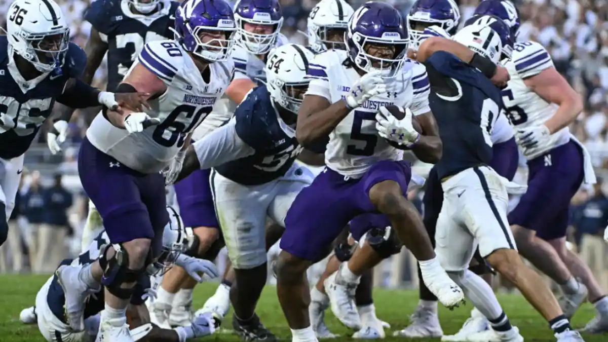 Northwestern Wildcats running back carries the ball against Penn State during a Big Ten football game