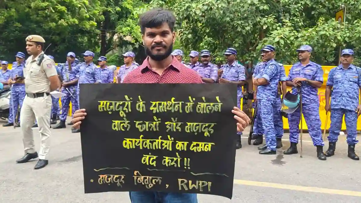 Young men gathered at Jantar Mantar in Delhi, carrying posters and raising their voices in support of workers.