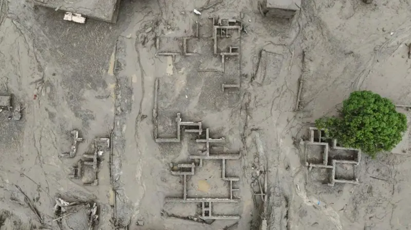An aerial view of buildings in Trishuli partially submerged by mud