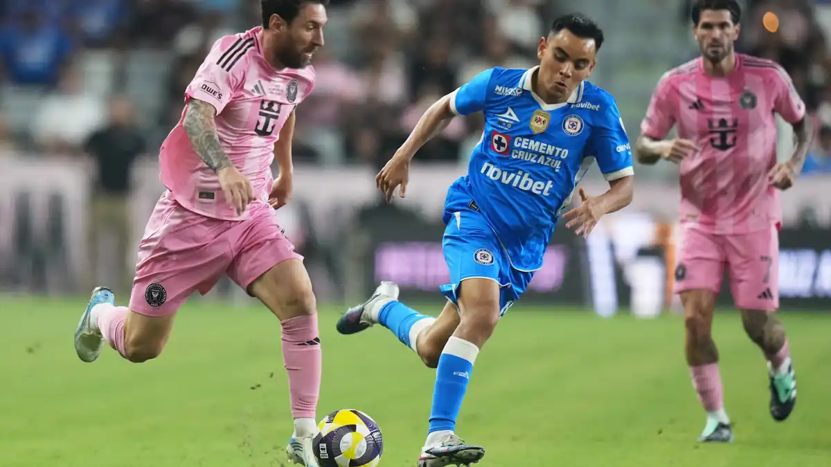 Inter Miami forward Leo Messi, left, runs with the ball as Cruz Azul midfielder Carlos Rodrguez defends during the first half of the Campeones Cup soccer match, Wednesday, Sept. 16, 2026, in Miami. 