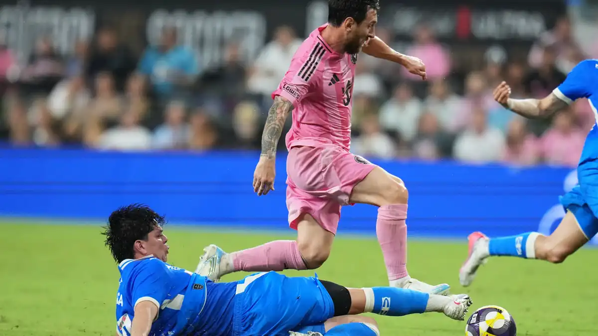 Cruz Azul midfielder Amaury Garca, left, falls to the field after he goes for the ball against Inter Miami forward Lionel Messi, right, during the first half of the Campeones Cup soccer match, Wednesday, Sept. 16, 2026, in Miami.