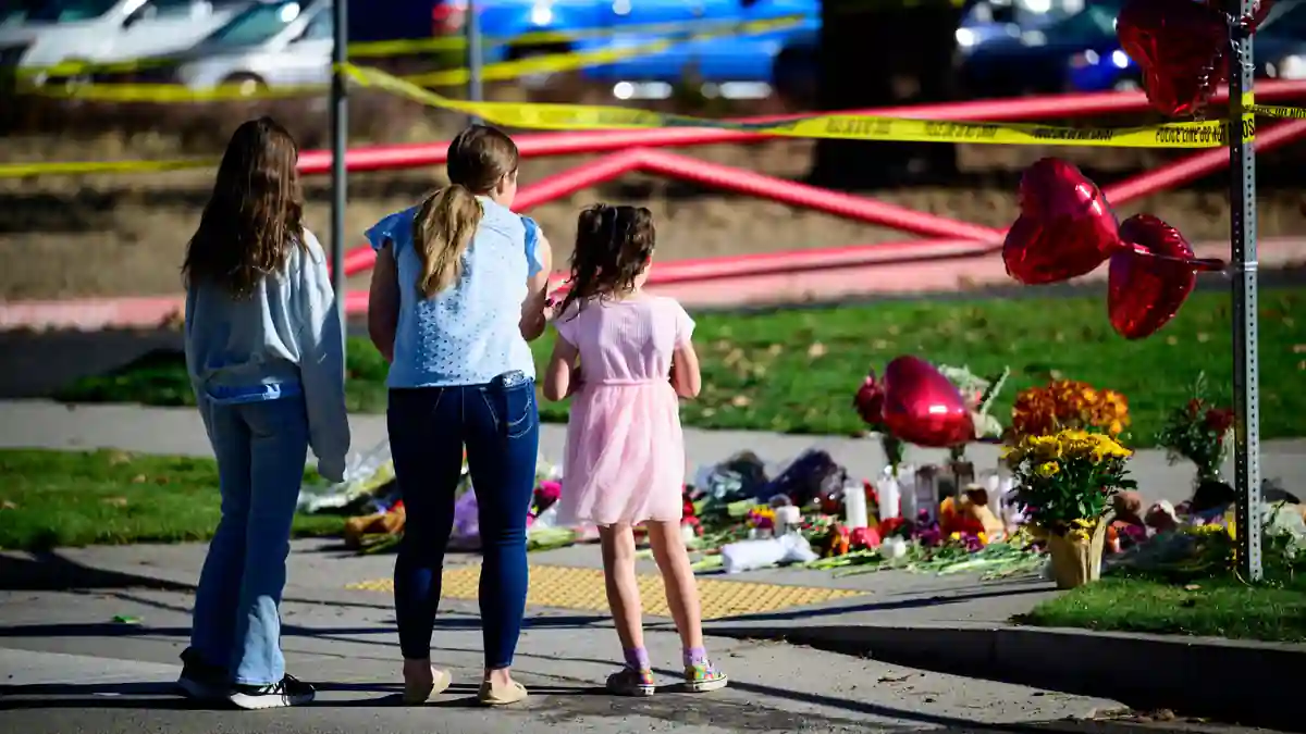 People at a memorial to the victims in Bend on Friday.