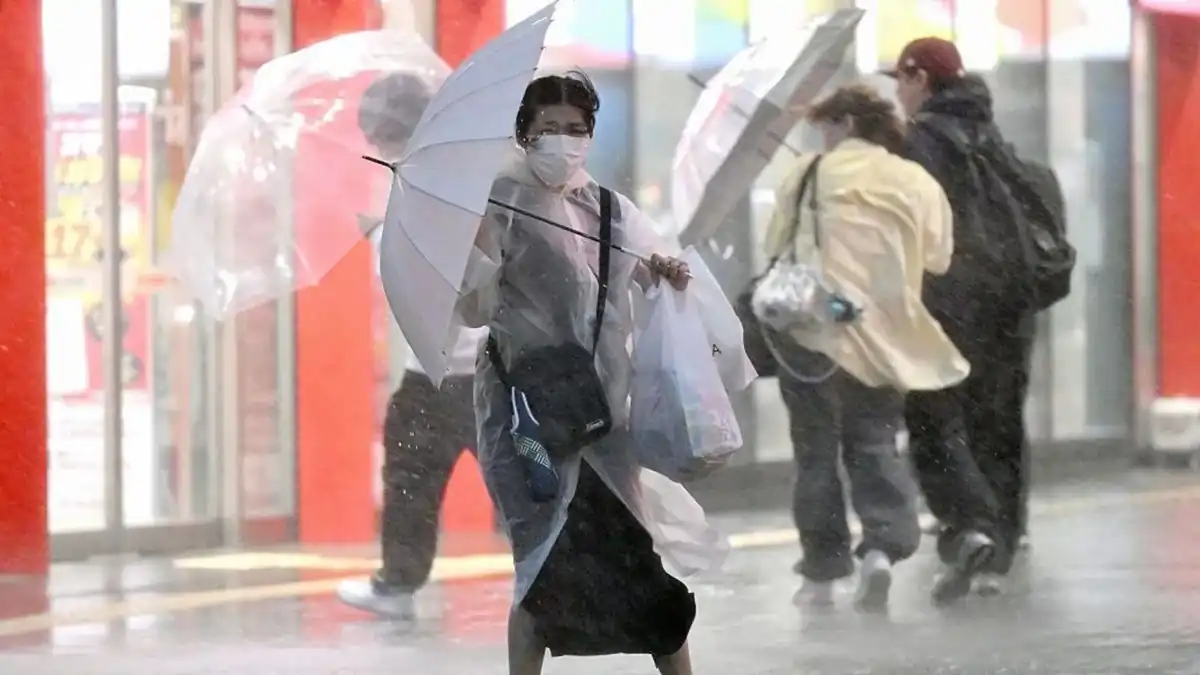 Woman also struggles with an umbrella in Chiba