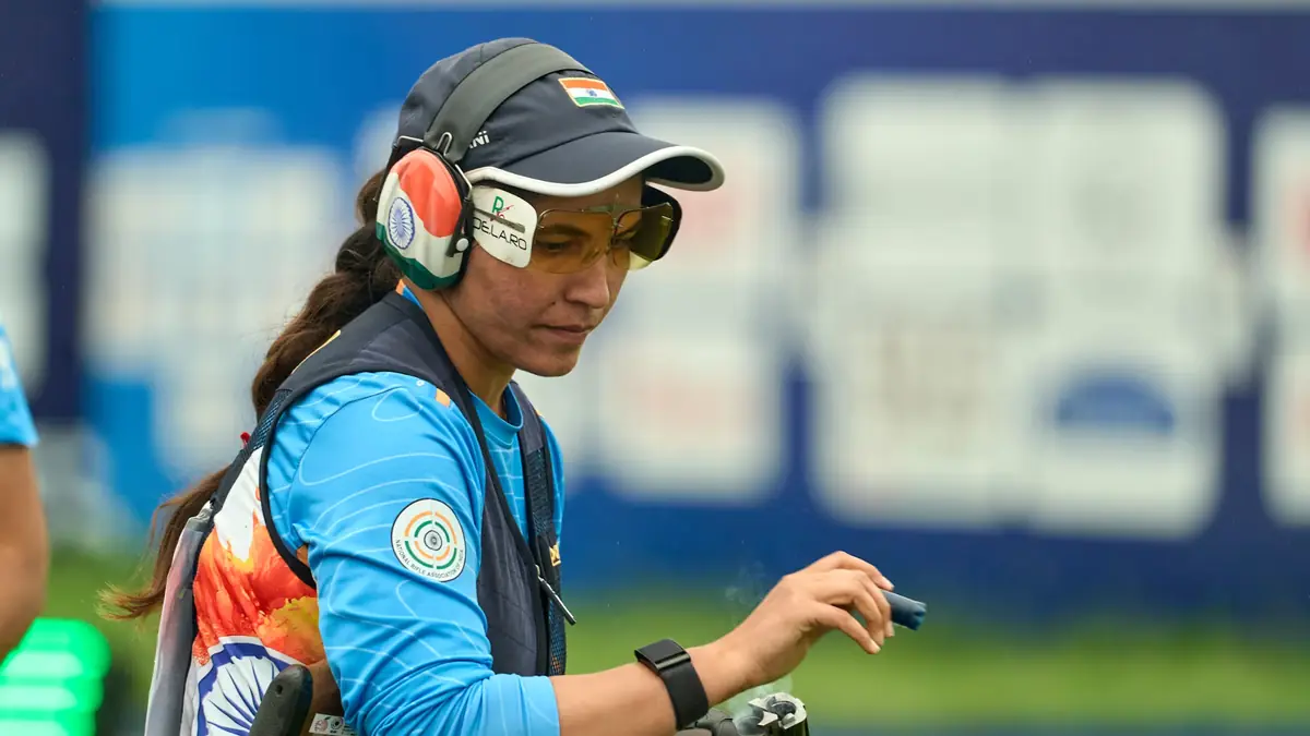 Indian shooter wearing protective shooting gear and glasses during an Asian Games 2026 shooting event.